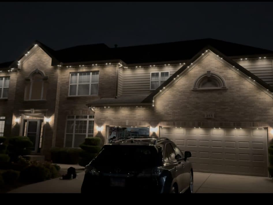 Two-story colonial home in Bloomingdale, IL with warm white permanent roofline lighting